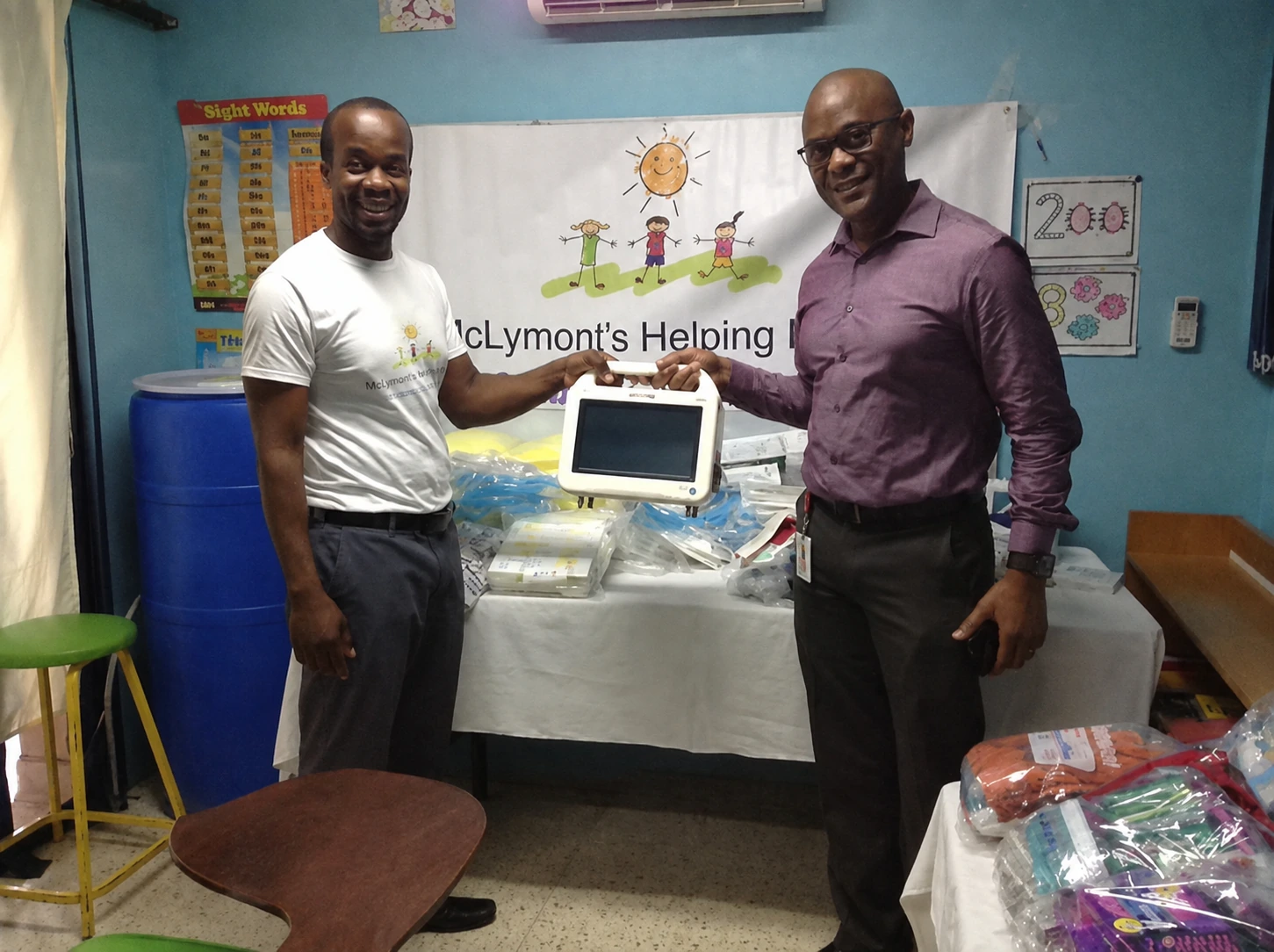 Foundation representatives presenting donated hospital equipment and supplies